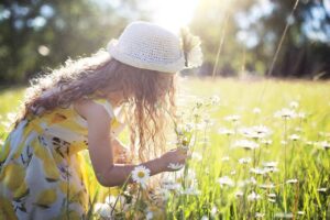 Girl in a field of daisies.